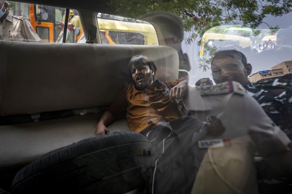 A student activist is tossed into a police vehicle during a protest demonstration against a new short-term government recruitment scheme for the military, in New Delhi, India, Friday, June 17, 2022. Hundreds of angry youths gave vent to their ire by burning train coaches, vandalizing railroad property and blocking rail tracks and highways with boulders as a backlash continued for a second straight day Friday against a new short-term government recruitment scheme for the military. Nearly 500 protesters vastly outnumbered policemen as they went on a rampage for more than an hour at Secundrabad railroad station in southern India.