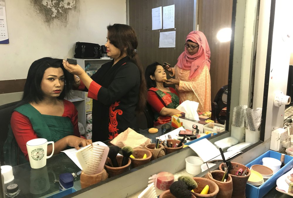 Bangladesh's first transgender news anchor Tashnuva Anan Shishir, left, gets ready to read news bulletin, in Dhaka, Bangladesh, Tuesday, March 9, 2021.