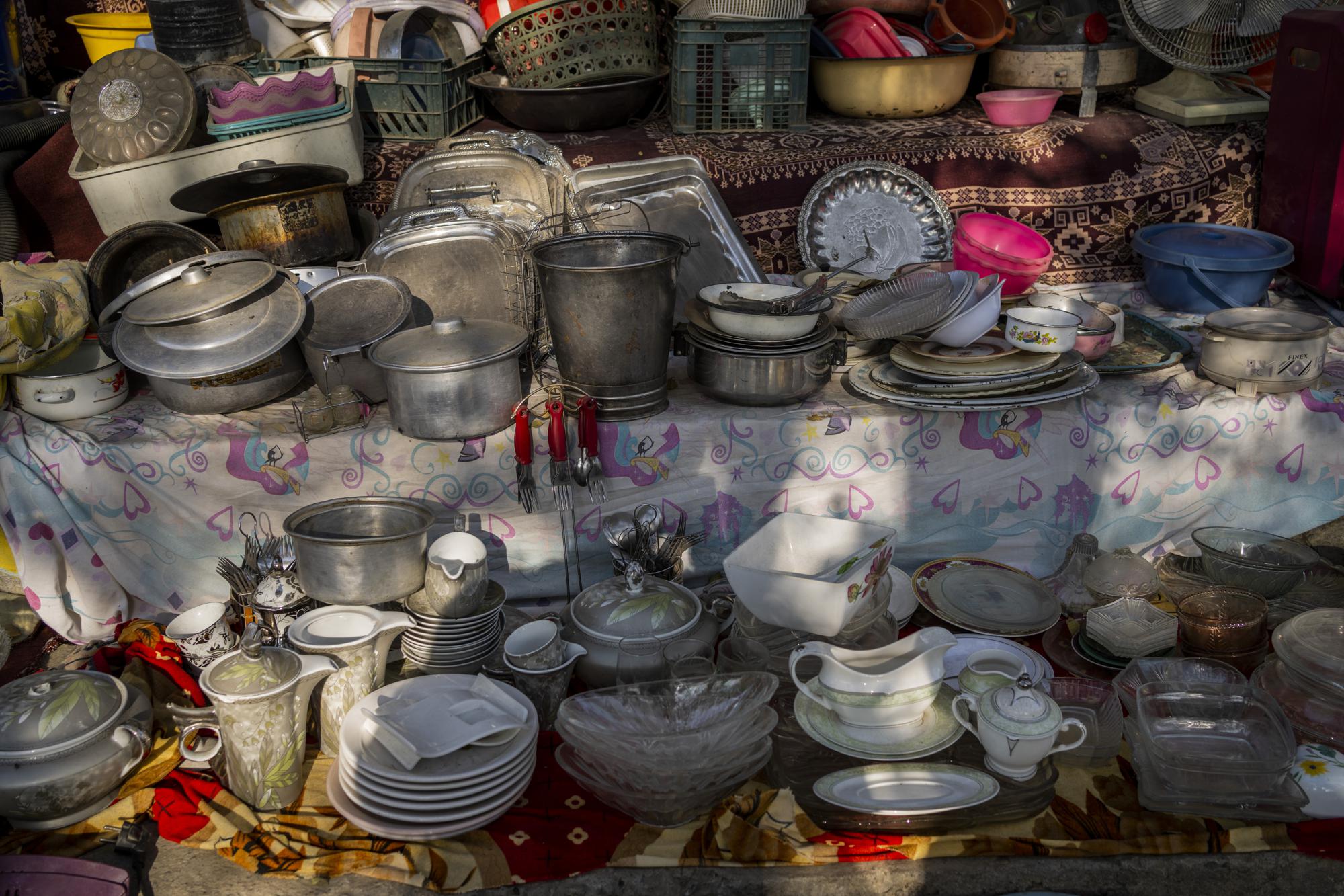 Household items are displayed at a flea market in Kabul, Afghanistan, Monday, Sept. 27, 2021. Second-hand markets have proliferated in Kabul where many families have sold their belongings before leaving the country or due to financial struggle. (AP Photo/Bernat Armangue)