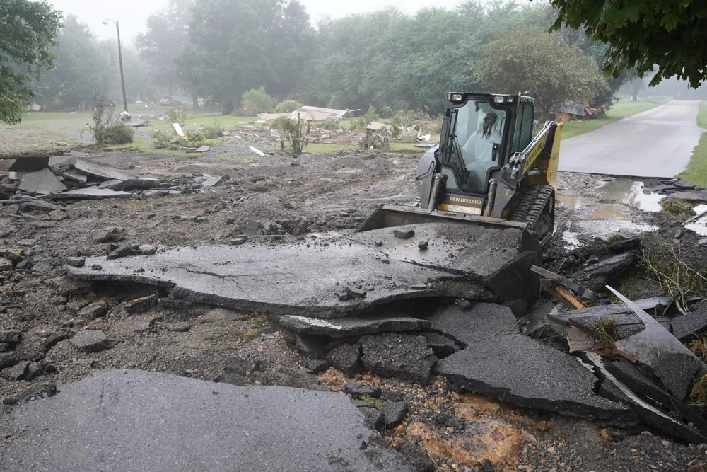 A road is repaired Sunday, Aug. 22, 2021, in McEwen, Tenn. The road was repaired Saturday after heavy rain washed part of it away, but the road was damaged again when more rain fell Saturday night. Heavy rains caused flooding in Middle Tennessee and have resulted in multiple deaths as homes and rural roads were washed away. (AP Photo/Mark Humphrey)