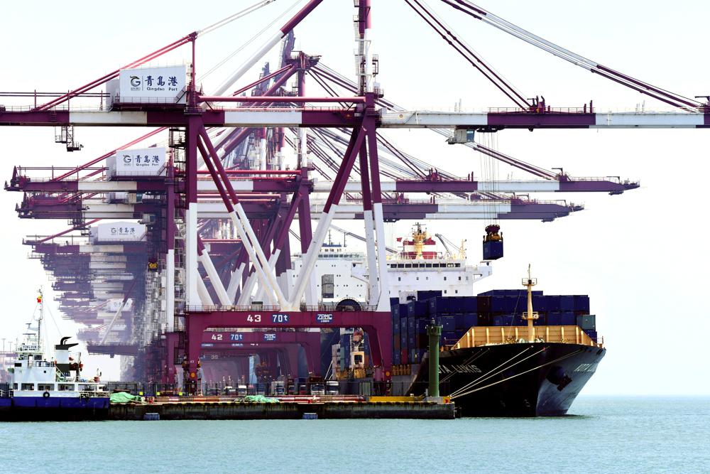 Container ships dock at a port in Qingdao in eastern China's Shandong province on Friday, June 4, 2021. China's exports surged nearly 28% in May while imports jumped 51% as demand rebounded in the U.S. and other markets where the pandemic is waning, though growth is leveling off after a stunning recovery from last year's slump. (Chinatopix via AP)