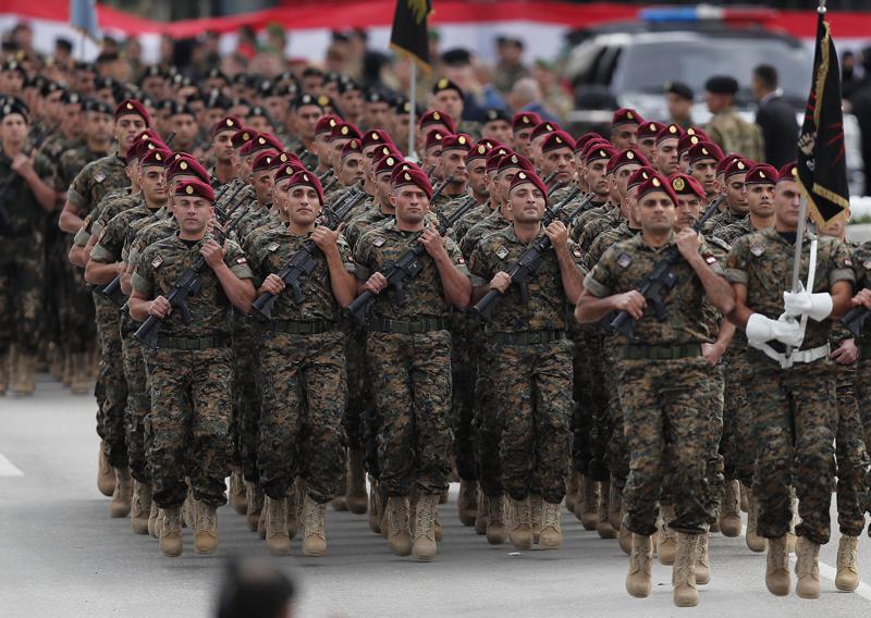 File - in this November 22, 2018 file photo, Lebanese army special forces march during a military parade to mark the 74th anniversary of Lebanon's independence from France in downtown Beirut, Lebanon. The currency collapse has wiped out the salaries of the U.S.-backed Lebanese military, placed unprecedented pressure on the army's operational capabilities with some of the highest attrition rates over the past two years, and raised concerns about its ability to continue playing a stabilizing role while sectarian tensions and crime are on the rise. (AP Photo/Hussein Malla, File)