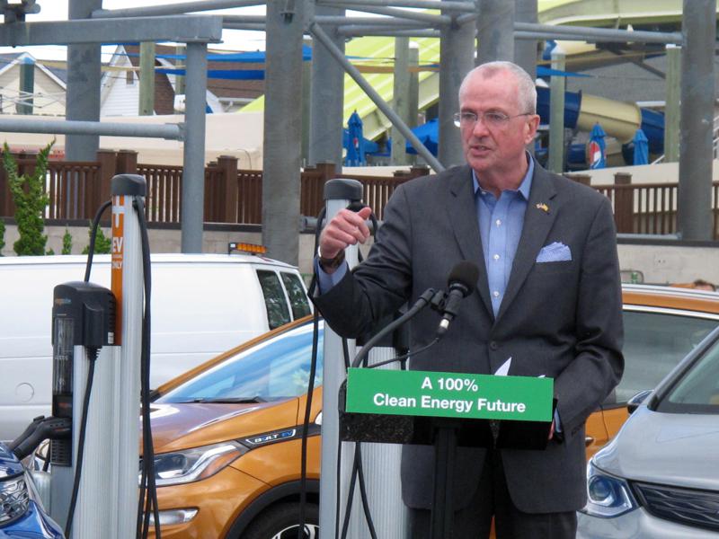 New Jersey Gov. Phil Murphy speaks at a news conference in a parking lot in Seaside Heights, N.J., Friday, July 9, 2021, where four electric vehicle charging stations were recently installed. The governor signed a package of clean energy bills aimed at making it easier for solar projects and electric vehicle charging stations. (AP Photo/Wayne Parry)