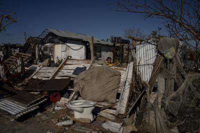 Una joven juega entre los restos de una casa destruida por el huracán Ian en La Coloma, en la provincia de Pinar del Río, Cuba, el miércoles 5 de octubre de 2022. Estados Unidos ha ofrecido ayuda humanitaria de emergencia a la población de Cuba para que se recupere de los estragos provocados por el huracán Ian. (AP Foto/Ramón Espinosa)