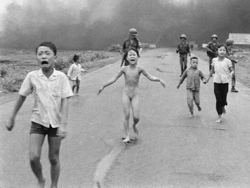 In this June 8, 1972 file photo taken by Huynh Cong "Nick' Ut, South Vietnamese forces follow terrified children, including 9-year-old Kim Phuc, center, as they run down Route 1 near Trang Bang after an aerial napalm attack on suspected Viet Cong hiding places. After making the photo, he set aside his camera, gave the badly burned girl water, poured more on her wounds, then loaded her and others into his AP van to take them to a hospital. When doctors refused to admit her, saying she was too badly burned to be saved, he angrily flashed his press pass. The next day, he told them, pictures of her would be displayed all over the world, along with an explanation of how the hospital refused to help. (AP Photo/Nick Ut, File)