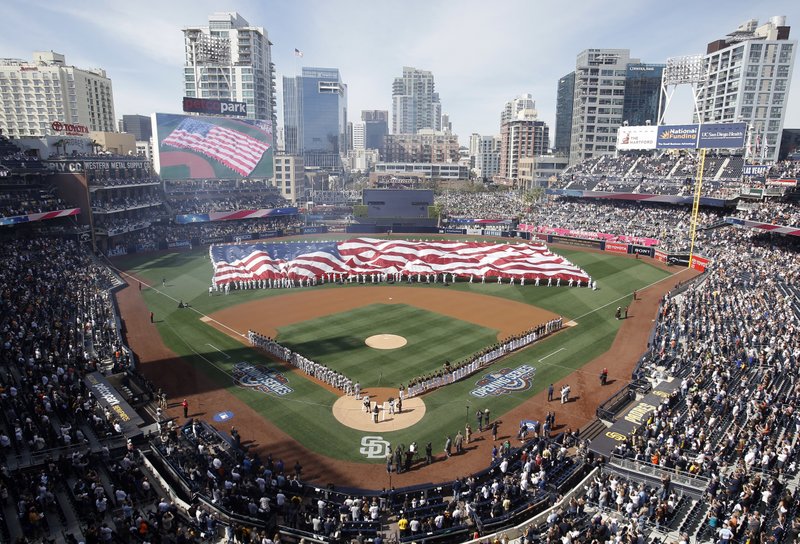 A giant U.S. flag is displayed during opening ceremonies for a baseball game between the San Diego Padres and the San Francisco Giants in San Diego, Friday, April 7, 2017. (AP Photo/Alex Gallardo)