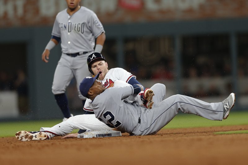 Atlanta Braves' Freddie Freeman (5) is tagged out by San Diego Padres shortstop Erick Aybar (8) as he tries to steal second base in the fifth inning of a baseball game, Saturday, April 15, 2017, in Atlanta. (AP Photo/John Bazemore)