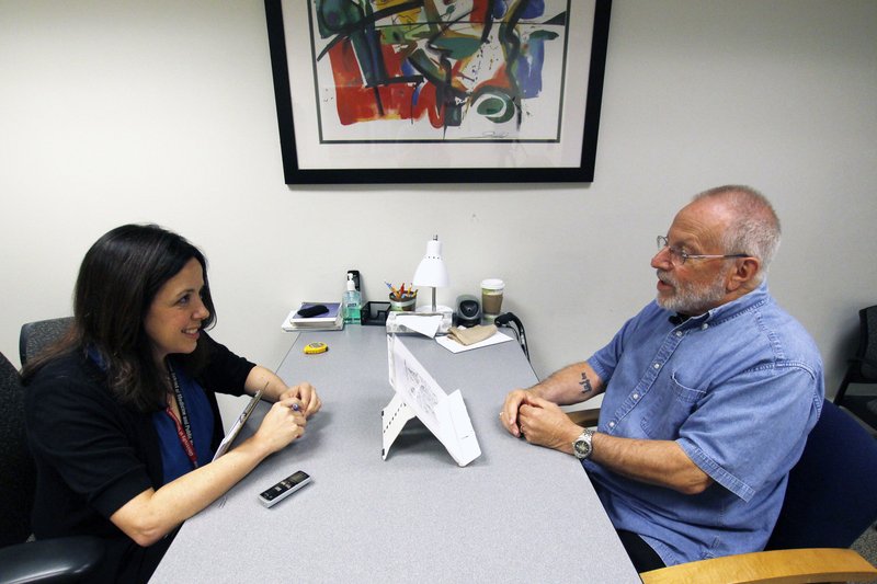  In this July 6, 2017 photo, Kim Mueller, left, administers a test to Alan Sweet, in which he describes an illustration, as part of a University of Wisconsin-Madison study on dementia. The study found that for some people subtle changes in everyday speech can be correlated with early mild cognitive impairment, which can be a precursor to Alzheimer's disease. (AP Photo/Carrie Antlfinger) 