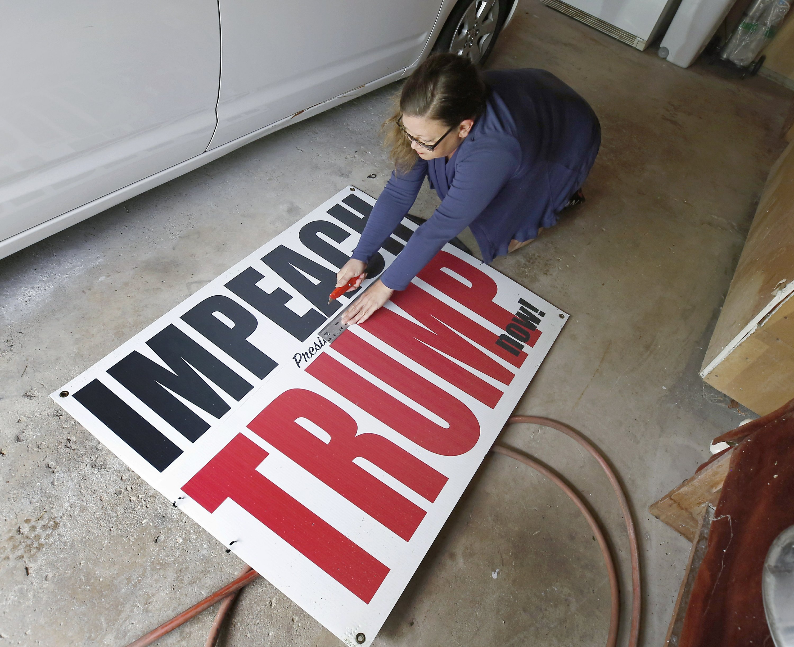 Illinois woman downsizes 'Impeach Trump' sign | AP News