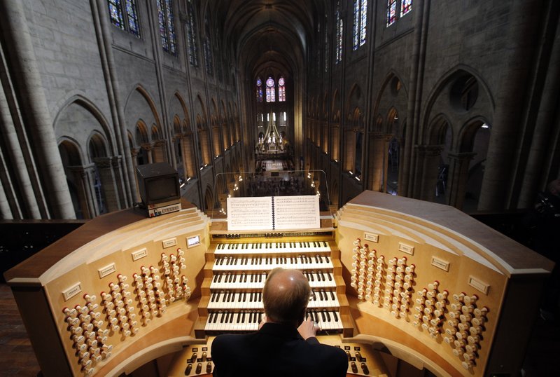 Philippe Lefebvre, 64, plays the organ at Notre Dame cathedral in Paris in May 2013. (Credit: Christophe Ena/AP.)