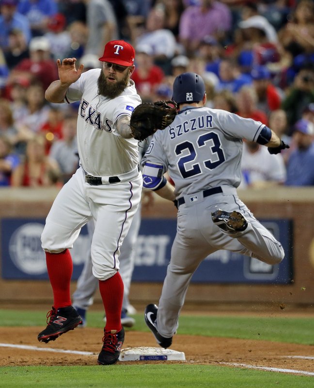 Texas Rangers first baseman Mike Napoli (5) reaches out to grab the throw from shortstop Elvis Andrus as San Diego Padres’ Matt Szczur (23) reaches safely on a single in the fourth inning of a baseball game, Wednesday, May 10, 2017, in Arlington, Texas. (AP Photo/Tony Gutierrez)
