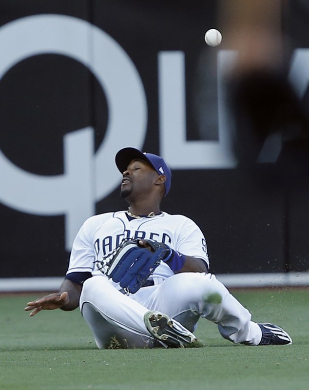 San Diego Padres' left fielder Jabari Blash slides but cannot catch the ball hit for a double by San Francisco Giants' Brandon Belt during the first inning of a baseball game in San Diego, Saturday, April 8, 2017. (AP Photo/Alex Gallardo)
