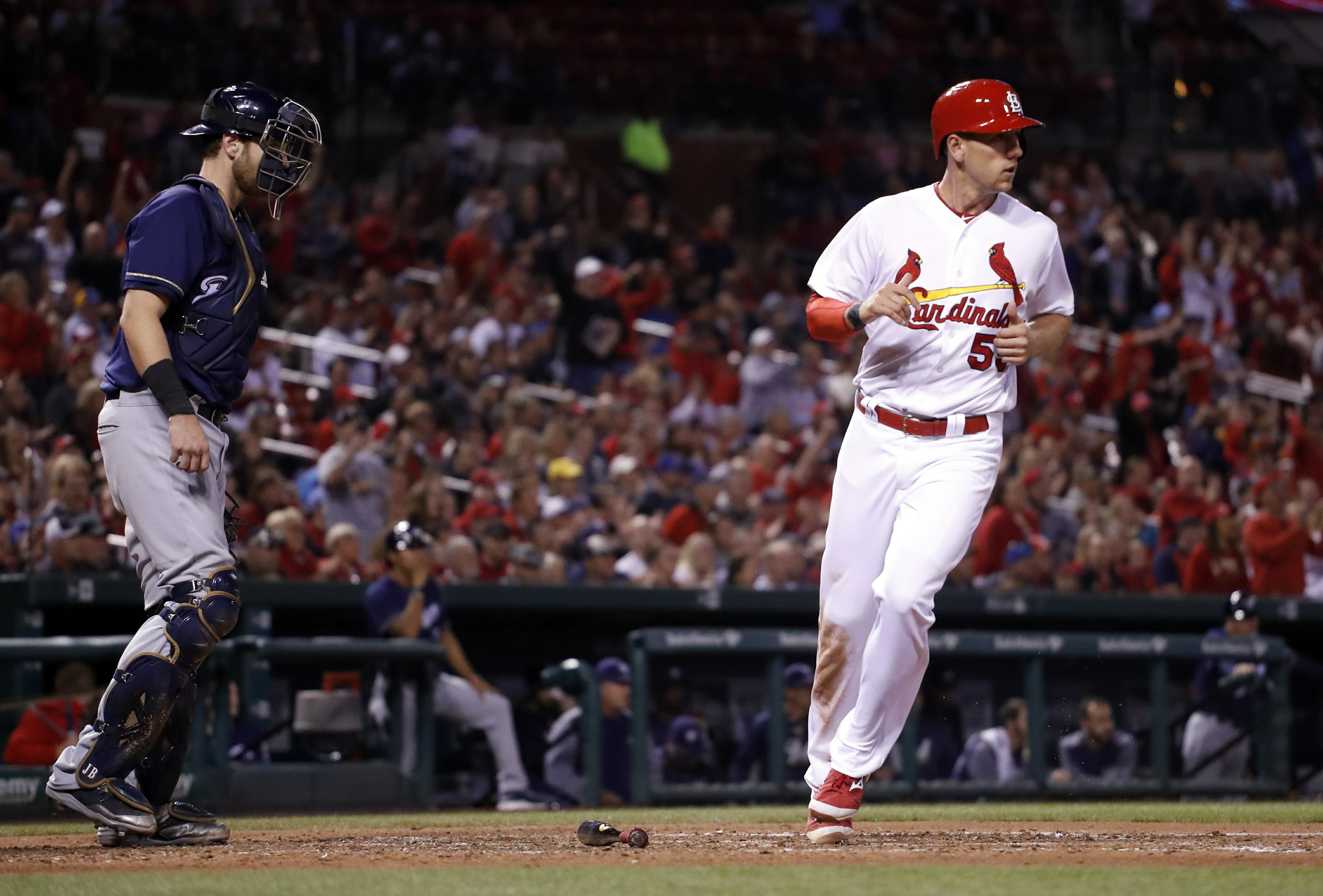 Woman hit by stray bullet during Cardinals game AP News