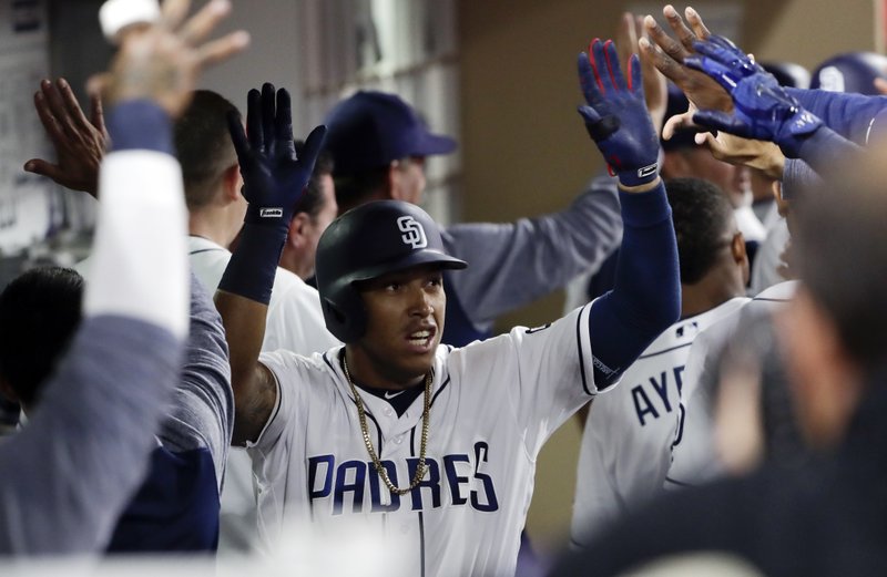 San Diego Padres' Yangervis Solarte is greeted by teammates in the dugout after his two-run home run during the sixth inning of a baseball game against the Colorado Rockies on Tuesday, May 2, 2017, in San Diego. (AP Photo/Gregory Bull)