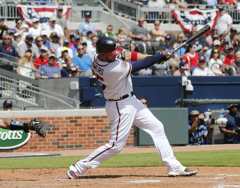 Atlanta Braves' catcher Tyler Flowers follows through on a two-run single in the fifth inning of a baseball game against the San Diego Padres Sunday, April 16, 2017, in Atlanta. (AP Photo/John Bazemore)