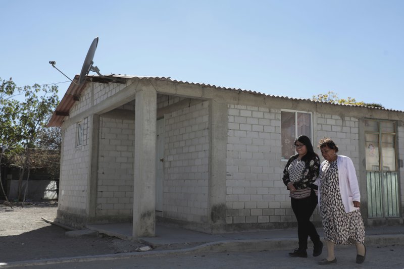 In this Dec. 23, 2016 photo, Tamara Alcala Dominguez walks with her grandmother Petra Bello Suarez in their home town of Molcaxac, Puebla, Mexico, during Alcala first return home since she left Mexico for the U.S. as a toddler. The women spent nearly two weeks catching up on 20 years, a reunion made bittersweet by the uncertainty ahead: They said their goodbyes just before President-elect Donald Trump took office amid vows to undo the protections his predecessor put in place, promises that leave Alcala worried about what comes next. (AP Photo/Pablo Spencer)