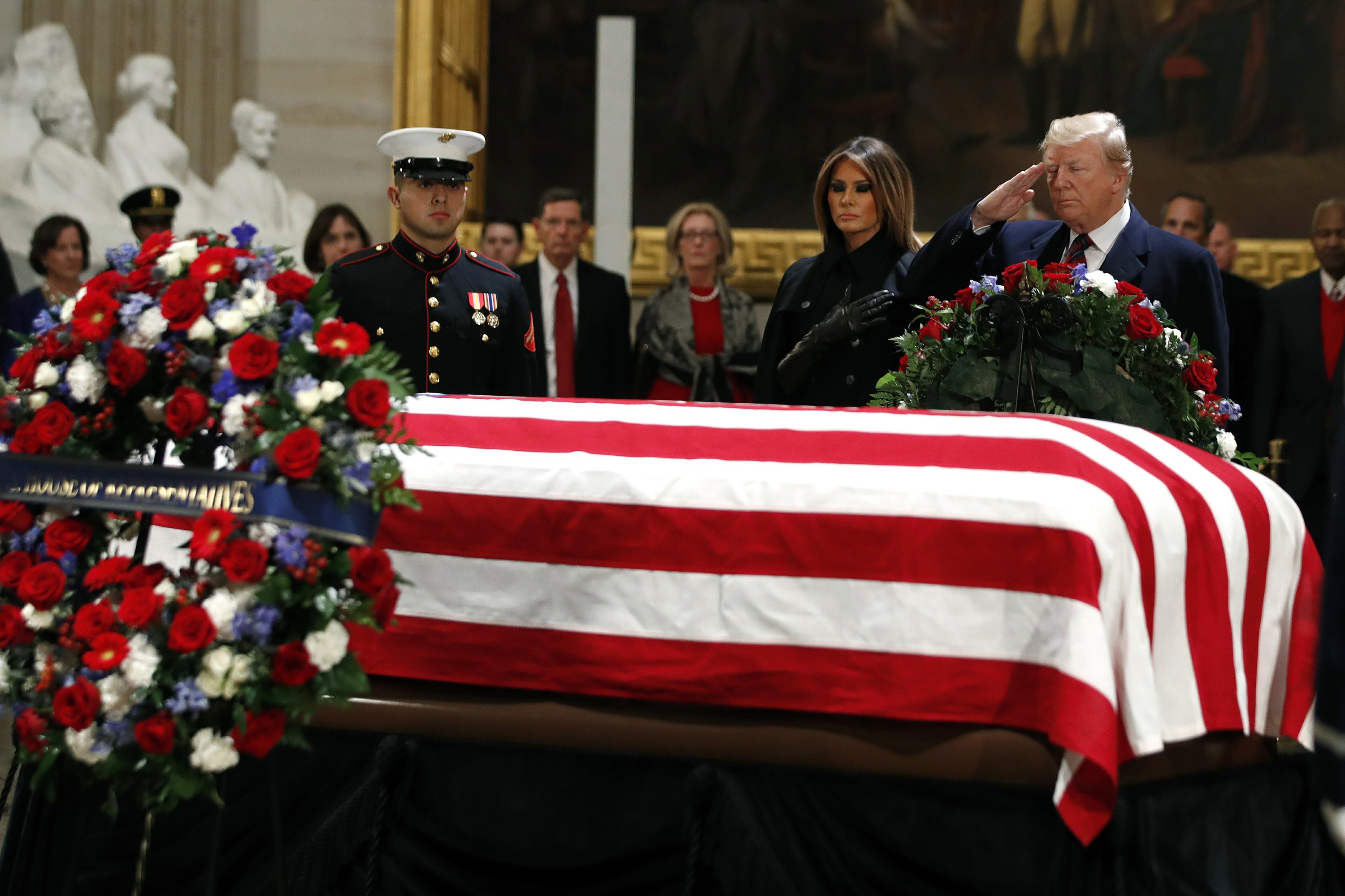 The Latest: Trump salutes Bush's casket in Capitol Rotunda