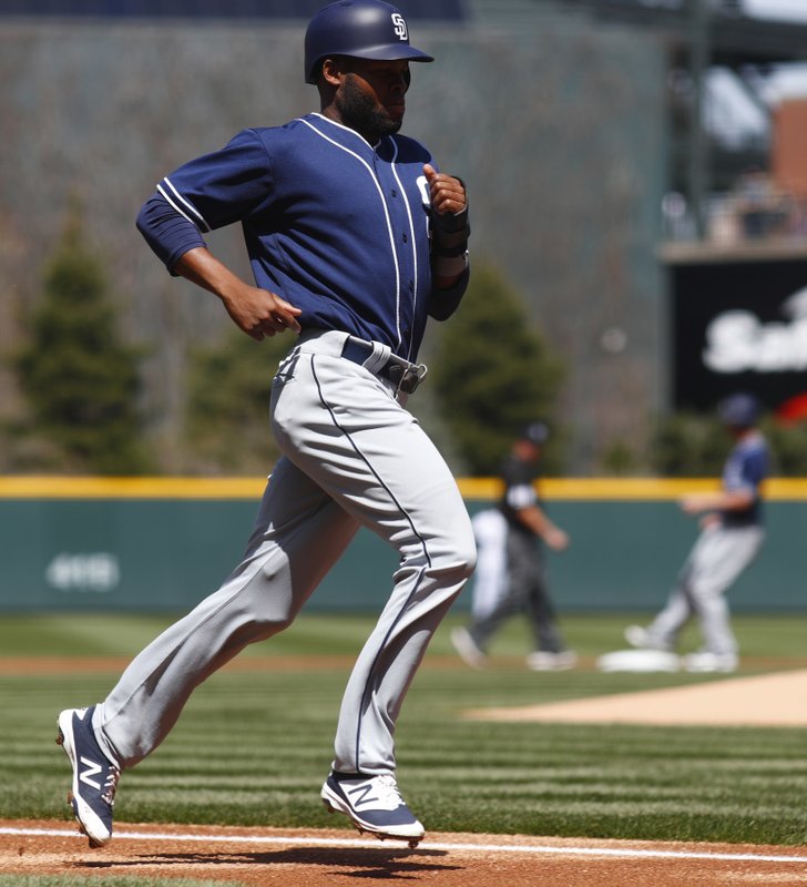 San Diego Padres' Manuel Margot, front, scores on an RBI-double hit by Wil Myers, back, who is pulling into second base in the first inning of a baseball game against the Colorado Rockies Wednesday, April 12, 2017, in Denver. (AP Photo/David Zalubowski)