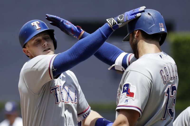 Texas Rangers' Ryan Rua, left, is greeted by teammate Joey Gallo after hitting a three-run home run during the first inning of a baseball game against the San Diego Padres, Tuesday, May 9, 2017, in San Diego. (AP Photo/Gregory Bull)