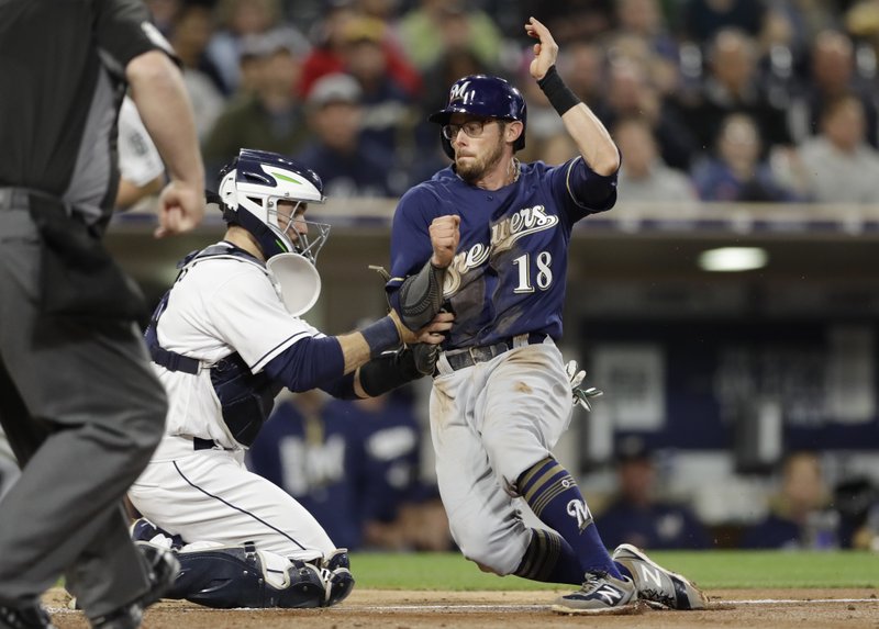 Milwaukee Brewers' Eric Sogard is tagged out by San Diego Padres catcher Austin Hedges trying to score from third base during the fourth inning of a baseball game, Tuesday, May 16, 2017, in San Diego. (AP Photo/Gregory Bull)