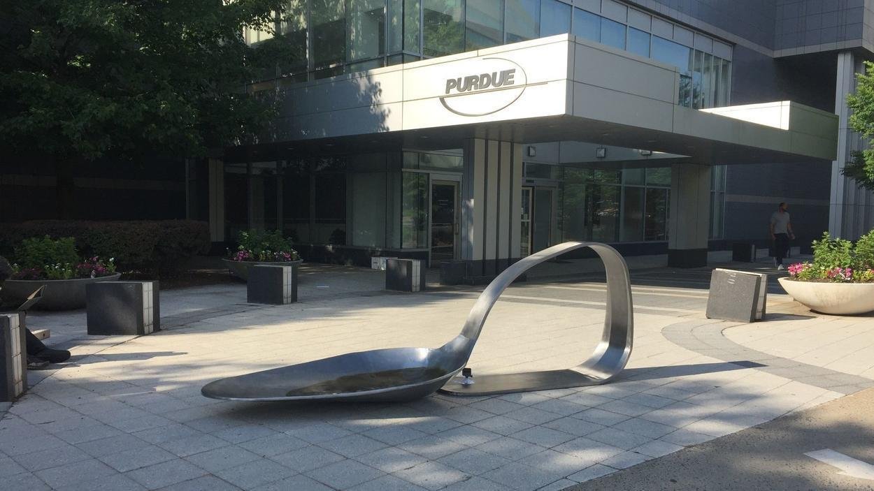Drug spoon sculpture placed outside drugmaker headquarters AP News