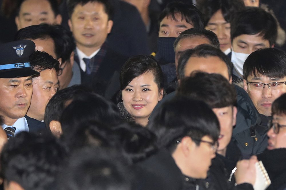  North Korean Hyon Song Wol, center, head of North Korea's art troupe, arrives at the Seoul Train Station in Seoul, South Korea, Sunday, Jan. 21, 2018. The head of a hugely popular girl band arrived in South Korea on Sunday across the rivals' heavily fortified border to check preparations for a Northern art troupe she also leads during next month's Winter Olympics in South Korea. (Korea Pool Photo via AP) 