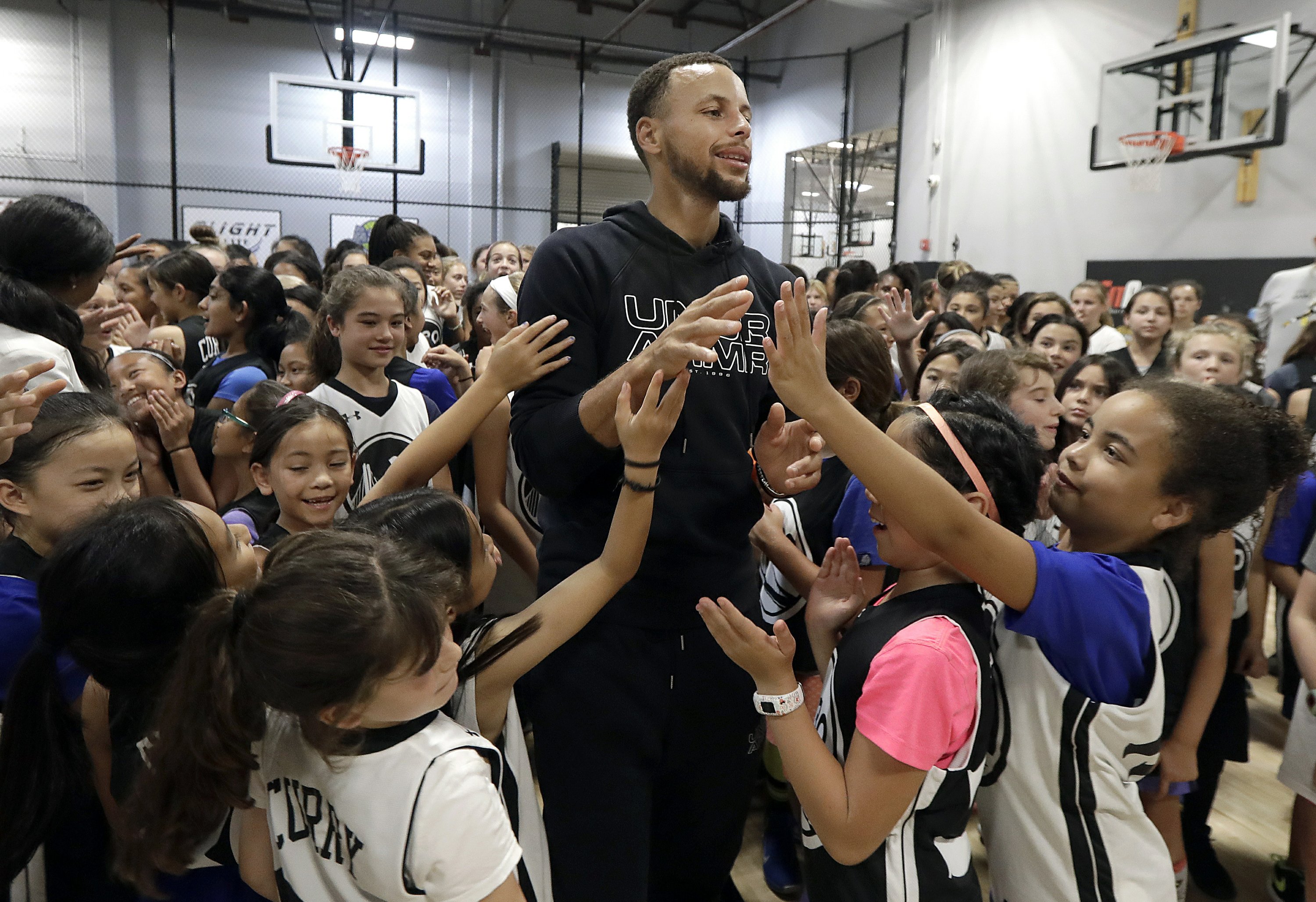 Stephen Curry supports women's game by hosting girls camps AP News