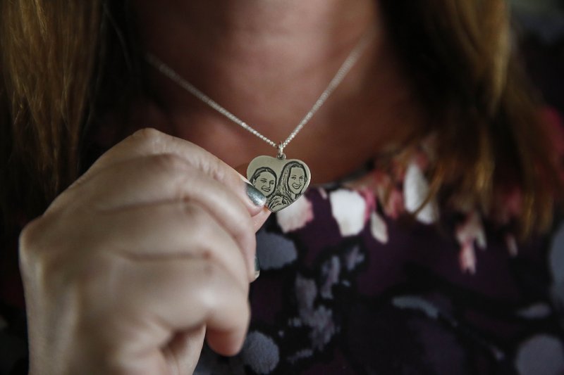 Lori Alhadeff holds a necklace of her and her daughter on Wednesday, Jan. 30, 2019, in Parkland, Florida. (AP Photo/Brynn Anderson)