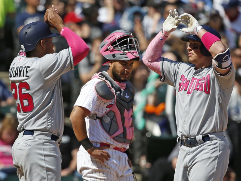 San Diego Padres' Hunter Renfroe, right, celebrates with Yangervis Solarte, left, after hitting a three-run home run as Chicago White Sox catcher Omar Narvaez reacts during the seventh inning of an interleague baseball game in Chicago, Sunday, May 14, 2017. (AP Photo/Nam Y. Huh)