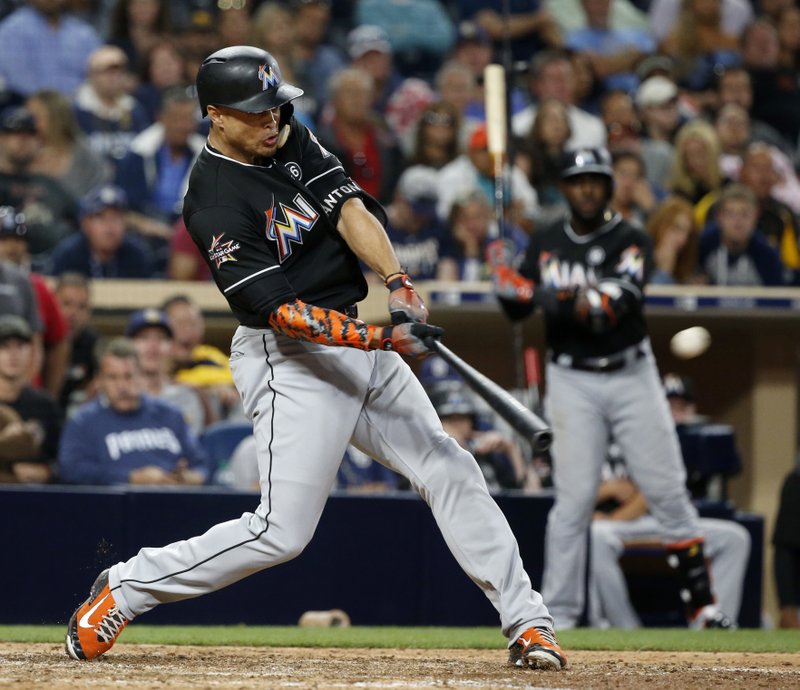 Miami Marlins' Giancarlo Stanton hits a two-run home run in the eleventh inning of a baseball game against the San Diego Padres in San Diego, Saturday, April 22, 2017. The Marlins won 6-3. (AP Photo/Christine Cotter)