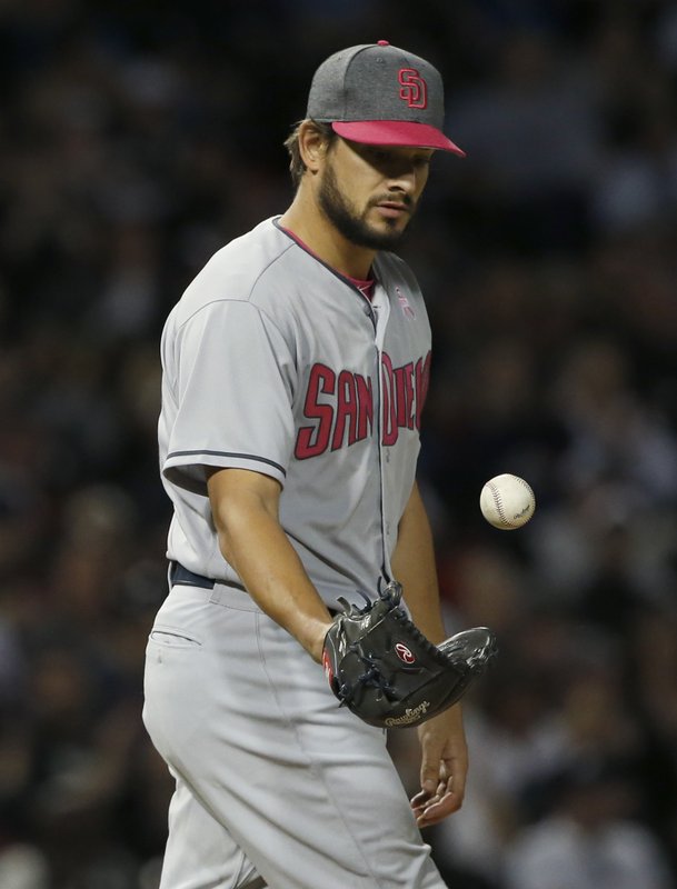 San Diego Padres relief pitcher Brad Hand tosses the ball after Chicago White Sox’s Tyler Saladino walked to first base during the ninth inning of an interleague baseball game in Chicago, Saturday, May 13, 2017. (AP Photo/Nam Y. Huh)