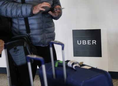 The Latest: Uber navigating criminal probes on road to IPO