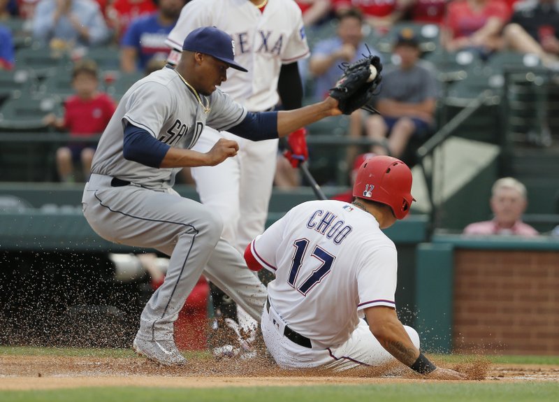 Texas Rangers designated hitter Shin-Soo Choo (17) scores on a wild pitch as San Diego Padres pitcher Luis Perdomo (61) tries to make the tag during the first inning of a baseball game, Wednesday, May 10, 2017, in Arlington, Texas. (AP Photo/Tony Gutierrez)
