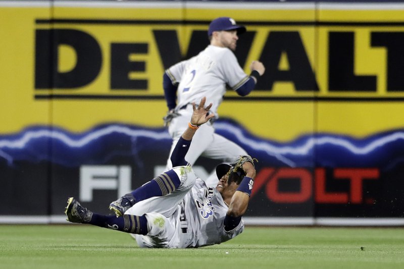 Milwaukee Brewers center fielder Keon Broxton, below, falls after missing a hit for an RBI triple by the San Diego Padres’ Luis Perdomo during the second inning of a baseball game Monday, May 15, 2017, in San Diego. (AP Photo/Gregory Bull)