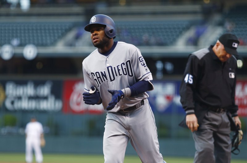 San Diego Padres' Manuel Margot applauds after crossing home plate on his home run off Colorado Rockies starting pitcher Antonio Senzatela during the first inning of a baseball game Tuesday, April 11, 2017, in Denver. (AP Photo/David Zalubowski)