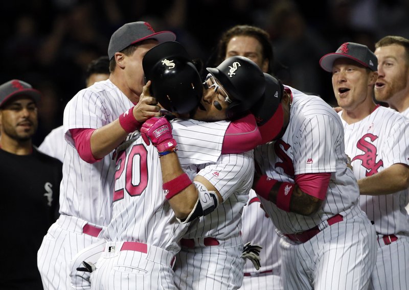 Chicago White Sox's Yolmer Sanchez, center right, celebrates with Tyler Saladino after they defeated the San Diego Padres in an interleague baseball game in Chicago, Saturday, May 13, 2017. (AP Photo/Nam Y. Huh)