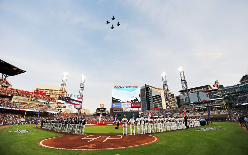 United States Navy fighter jets fly over SunTrust Park during the national anthem before a baseball game between the Atlanta Braves and the San Diego Padres in Atlanta, Friday, April 14, 2017. The Braves are playing their first regular-season game in SunTrust Park, the new suburban stadium that replaced Turner Field. (AP Photo/John Bazemore)