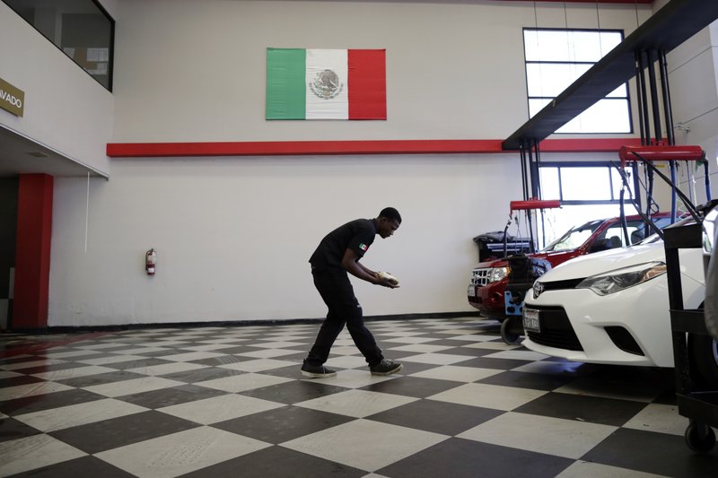 Haitian employee at Millan's car wash, Photo: Gregory Bull/AP