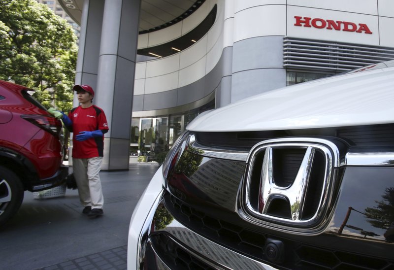 An Employee Of Honda Motor Co Cleans A Car Displayed At Its Headquarters In Tokyo Tuesday July 31 2018 Profits Jumped 178 Percent The