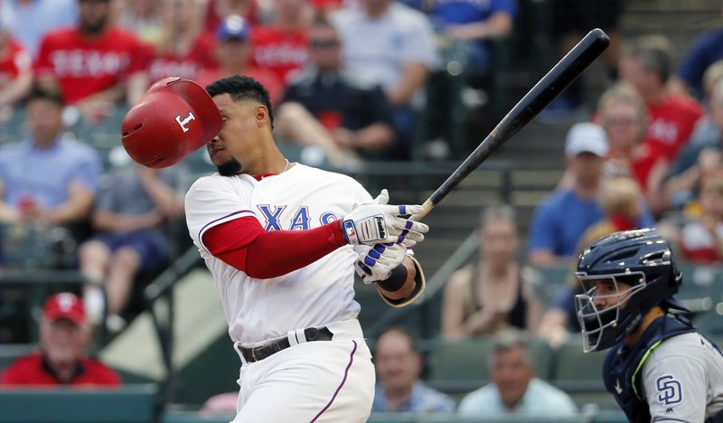 Texas Rangers center fielder Carlos Gomez loses his helmet as he takes a swing for a stake against San Diego Padres starting pitcher Luis Perdomo (61) during the first inning of a baseball game, Wednesday, May 10, 2017, in Arlington, Texas. (AP Photo/Tony Gutierrez)