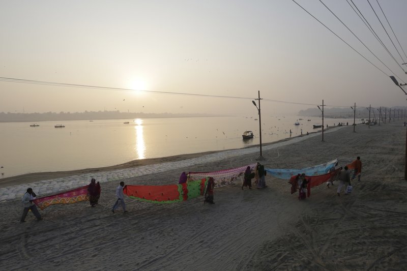 In this Thursday, Jan. 5, 2017, file photo, Hindu devotees dry their clothes after taking a dip at Sangam, the confluence of rivers Ganges, Yamuna, and mythical Saraswati in Allahabad, India. A court in northern India has granted the same legal rights as a human to the Ganges and Yamuna rivers, considered sacred by nearly a billion Indians. The Uttaranchal High Court in Uttarakhand state ruled Monday, March 20, 2017, that the two rivers be accorded the status of living human entities, meaning that if anyone harms or pollutes the rivers, the law would view it as no different from harming a person.  In this Thursday, Jan. 5, 2017, file photo, Hindu devotees dry their clothes after taking a dip at Sangam, the confluence of rivers Ganges, Yamuna, and mythical Saraswati in Allahabad, India. A court in northern India has granted the same legal rights as a human to the Ganges and Yamuna rivers, considered sacred by nearly a billion Indians. The Uttaranchal High Court in Uttarakhand state ruled Monday, March 20, 2017, that the two rivers be accorded the status of living human entities, meaning that if anyone harms or pollutes the rivers, the law would view it as no different from harming a person.