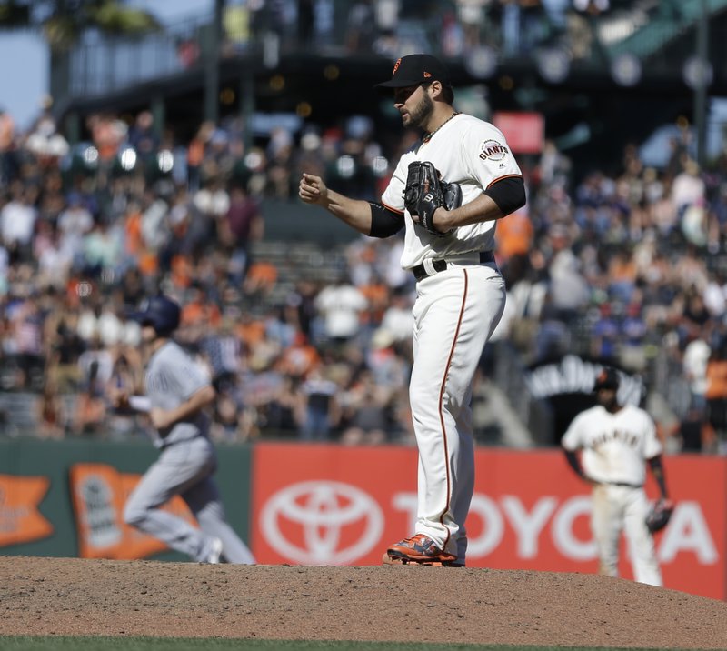 San Francisco Giants' George Kontos waits for San Diego Padres' Wil Myers, left, to run the bases after hitting a three-run home run in the 12th inning of a baseball game, Sunday, April 30, 2017, in San Francisco. (AP Photo/Ben Margot)