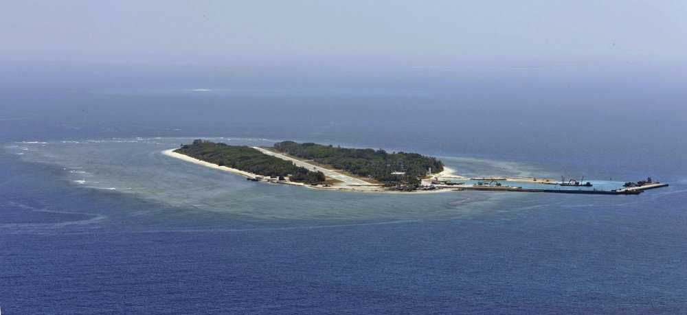 FILE - In this Wednesday, March 23, 2016, file photo, provided by Taiwan's Ministry of Defense, shows an aerial view of Taiwan's Taiping island, also known as Itu Aba, in the Spratly archipelago, roughly 1600 kms. (1000 miles) south of Taiwan. Taiwan’s coast guard said annual live-fire exercises conducted at Taiping island in the Spratly island group were routine and didn’t endanger shipping. Neighboring countries were informed in advance of the exercises carried out on last week, the coast guard said. (Taiwan's Ministry of Defense via AP)