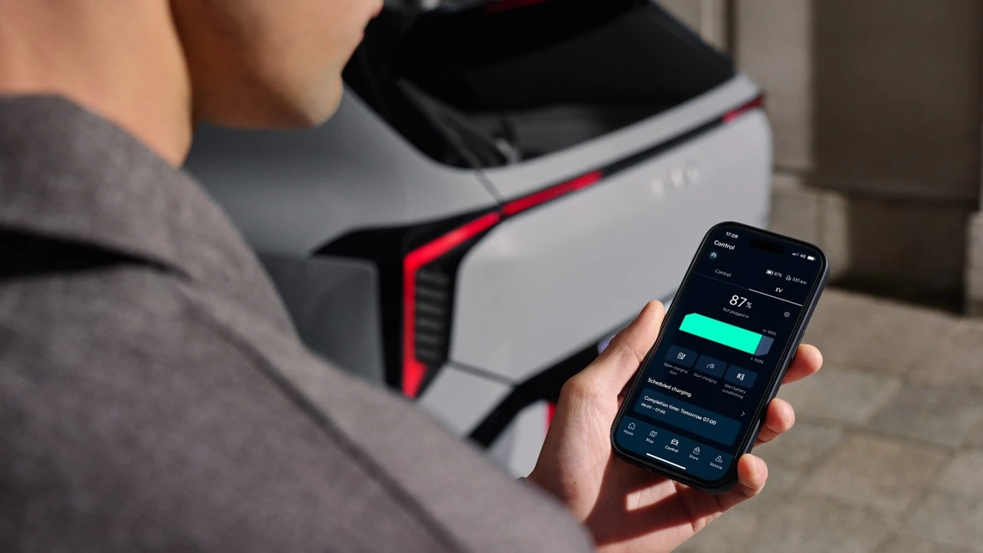 Kia App på en mobiltelefon bredvid en Kia