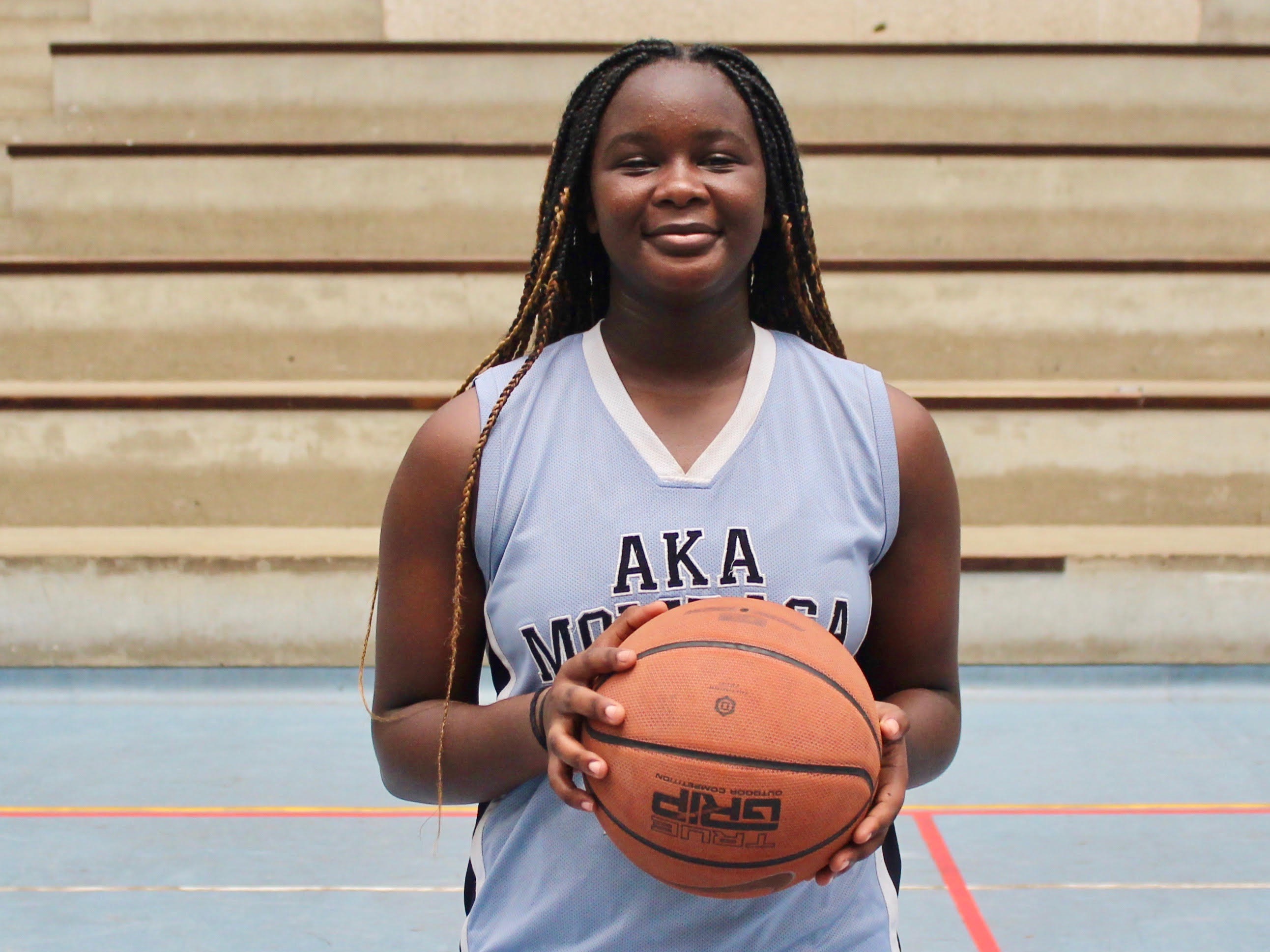 Joy Alendi posing for a photo at the mph after victory at sub-county basketball games.