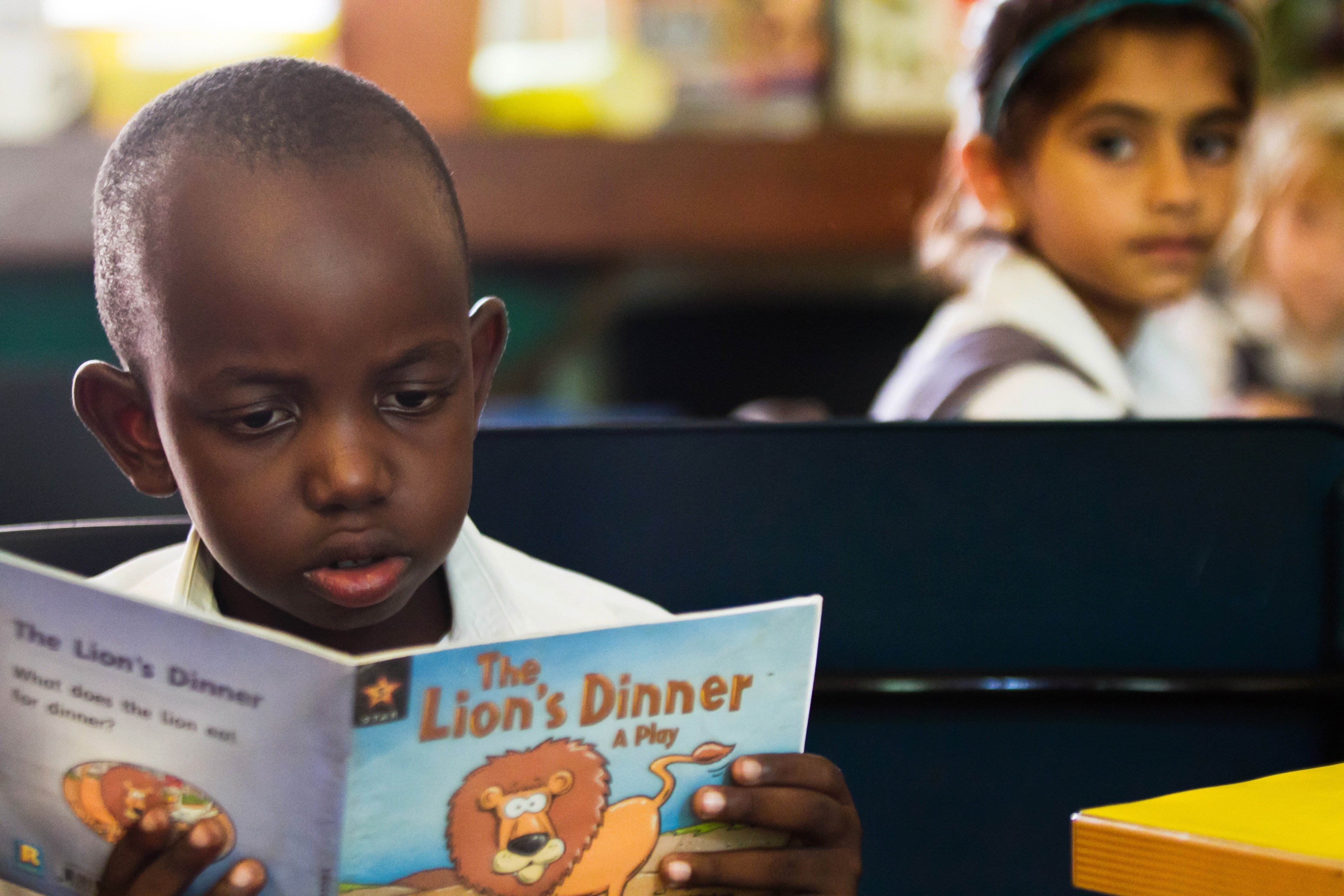 Student reading a book in the Junior School library