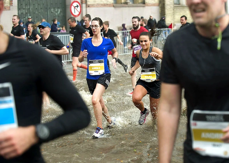 Løbere i Københavns maraton, gennem vandpytter.