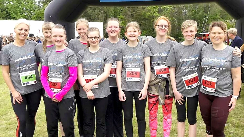 The Godena Race participants at the finish line. Smiling runners in a group photo.