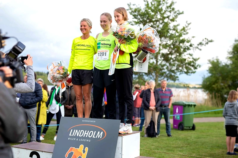 Ulbølle Halvmaraton vinderpodie. Stolte løbere med blomster.