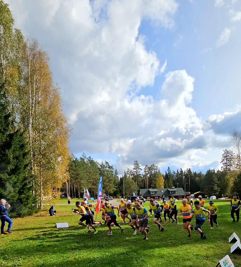 Race start: athletes run on the grass.
